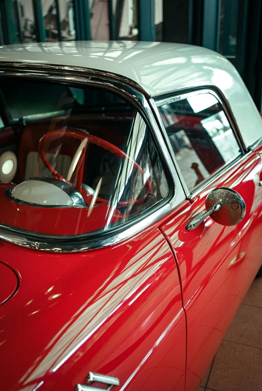 the view from inside a classic red car's rear window