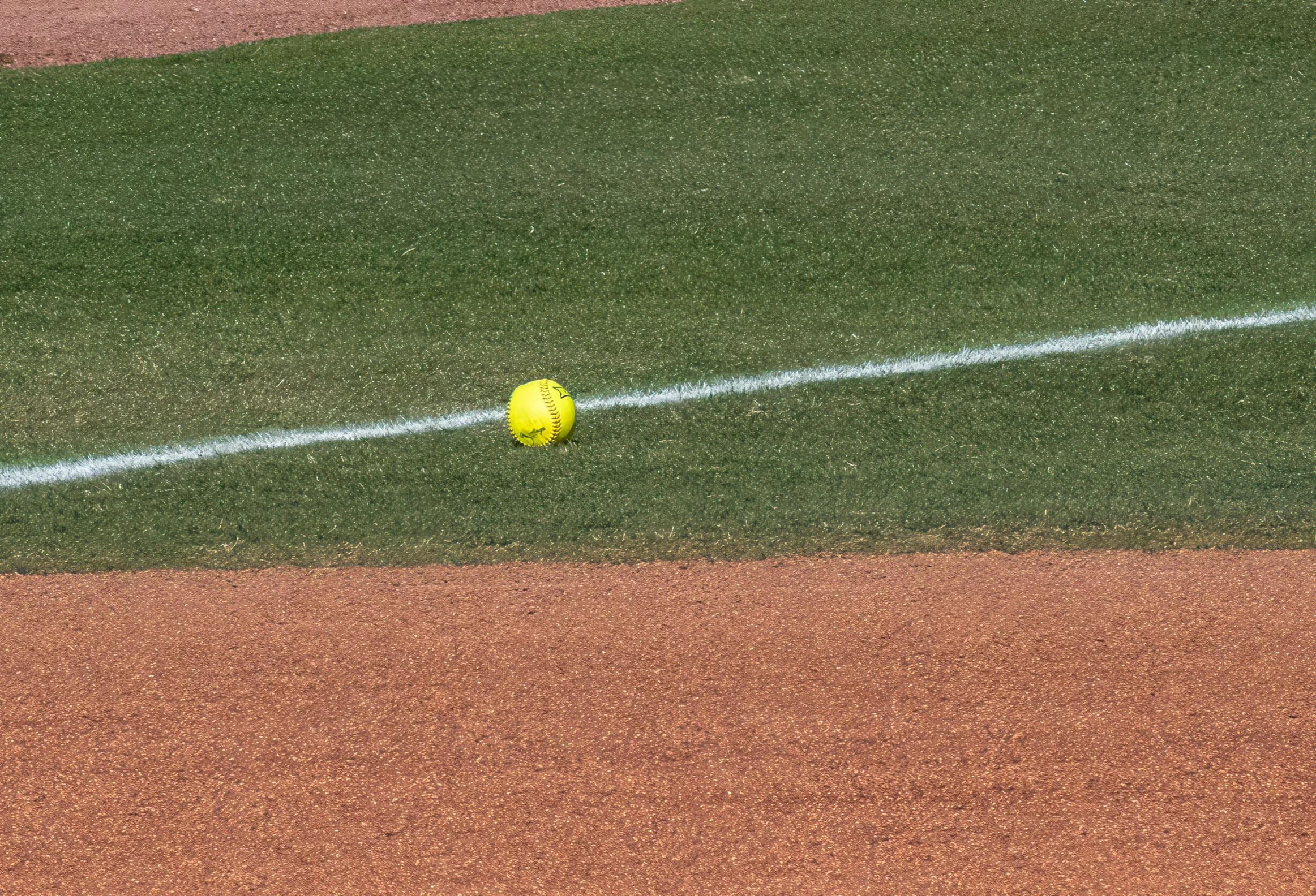 a baseball and ball on the field in the middle of the play