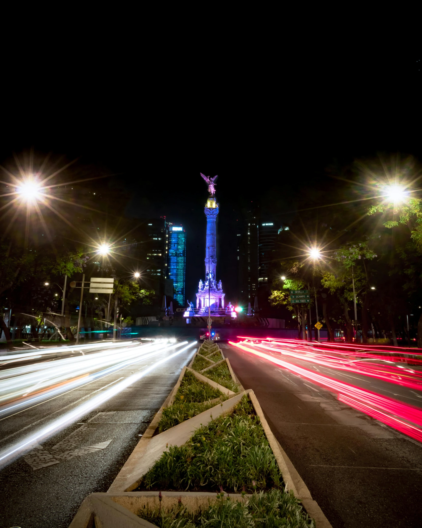 a street lined with lots of lights in front of buildings