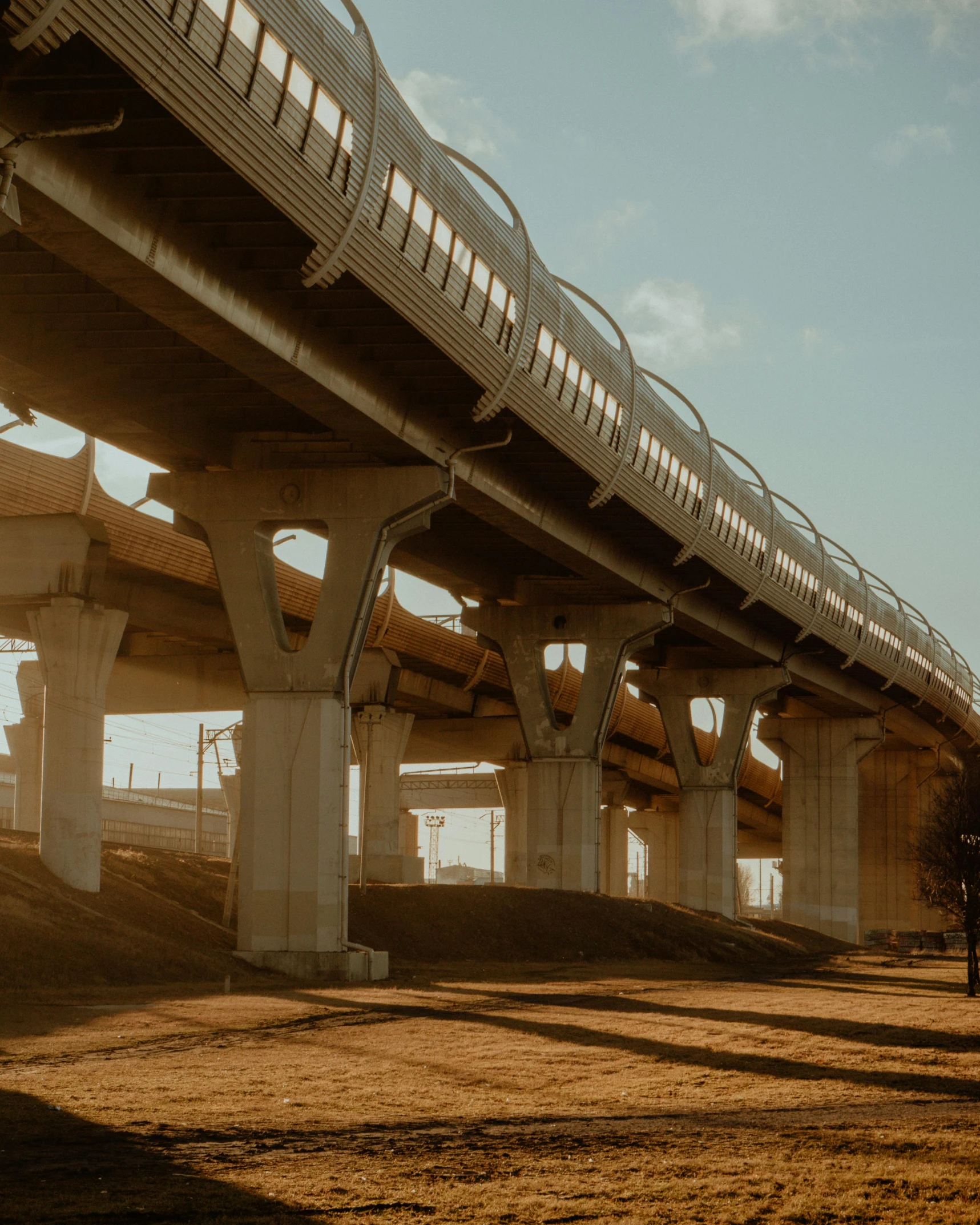 a large bridge over some dirt near a highway