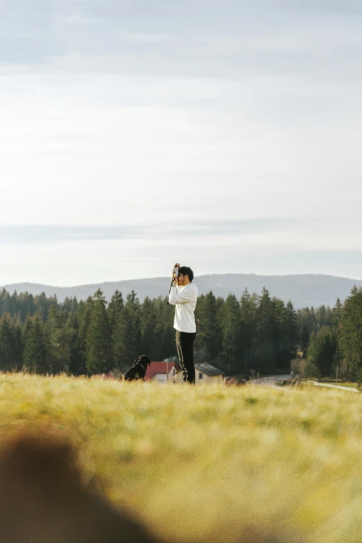 a man flying a kite in a field