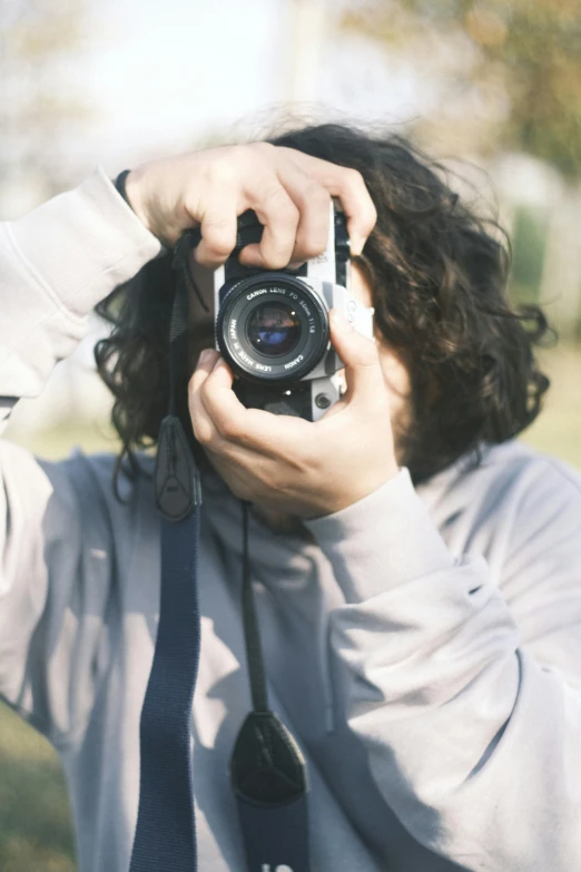 a person holding a camera to their face