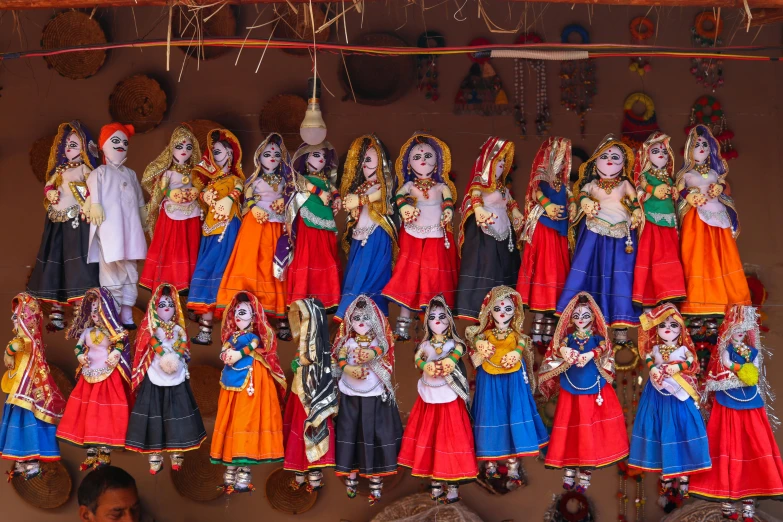 colorful religious figures on display for sale at an indian market