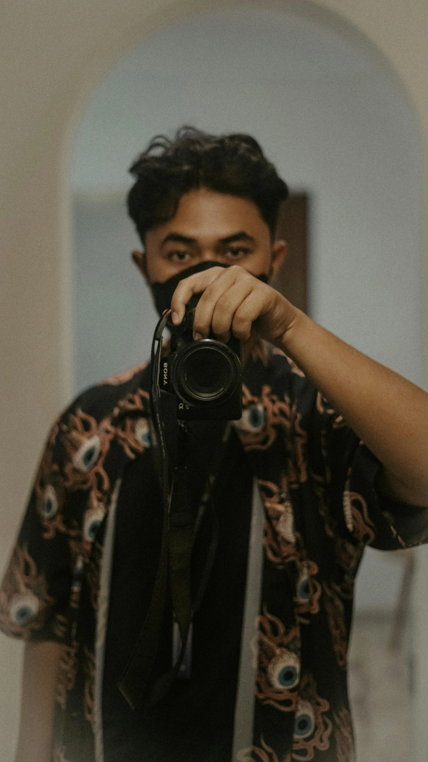 man wearing black sunglasses taking a po with camera