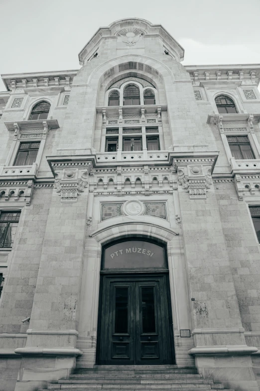 an old stone building with large arched windows and pillars