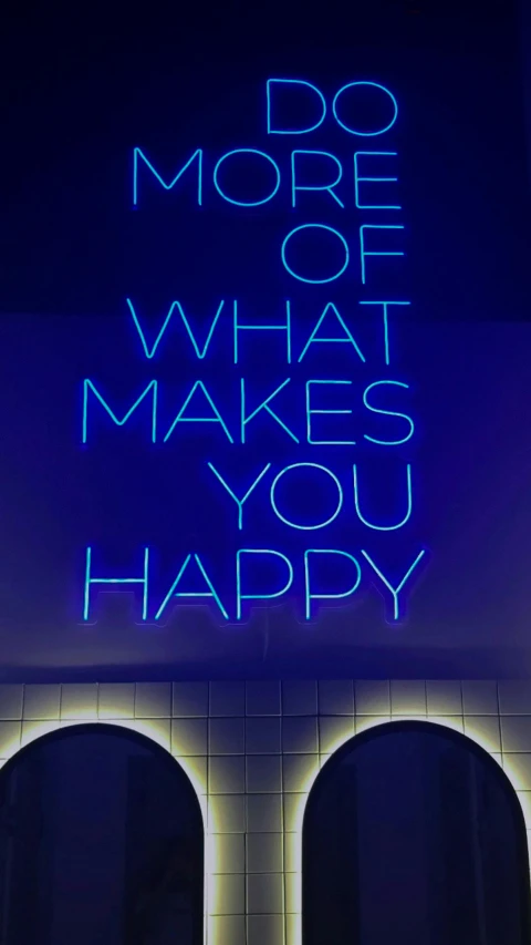 a neon sign that is on the side of a building