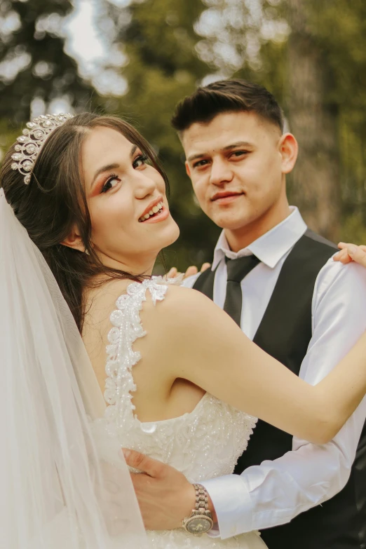 a woman and man in the forest standing together