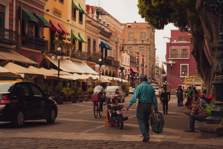 people walking, biking and driving through a city area