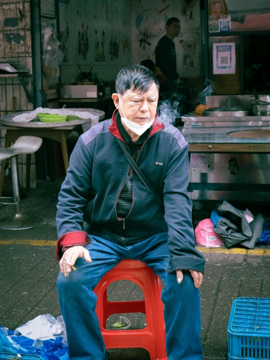 a man is sitting on the front of his home made red toy