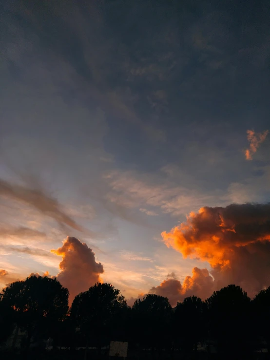 the sky with some clouds that are red and blue