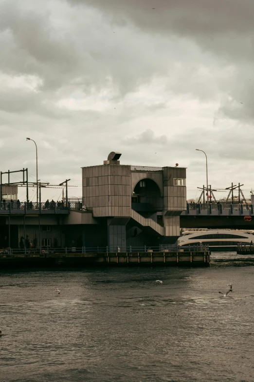 a bridge over water with buildings on top and boats below