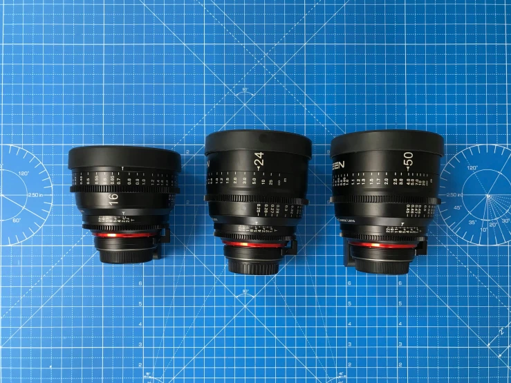 three lenses are placed on a blue background