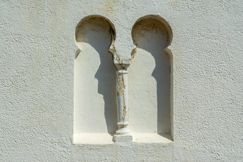 the corner of the wall is shaped as if two archways