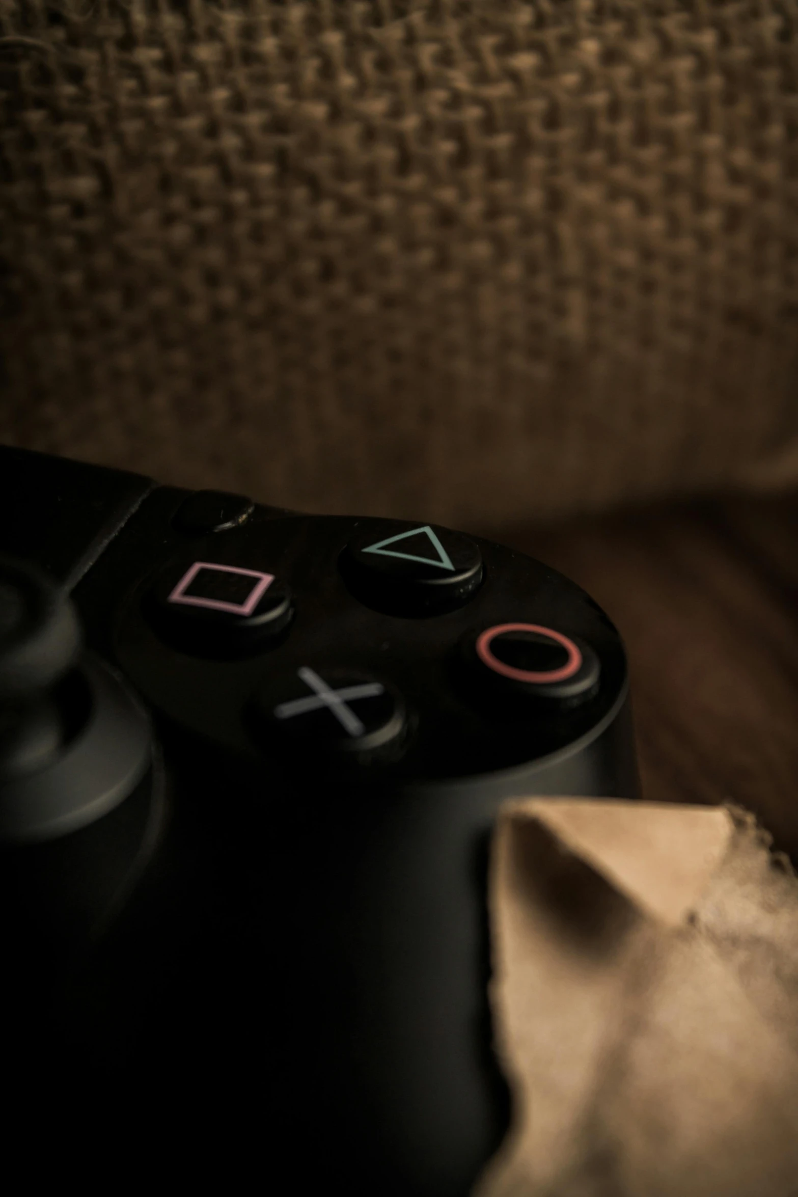 the controls of a black game controller on a chair