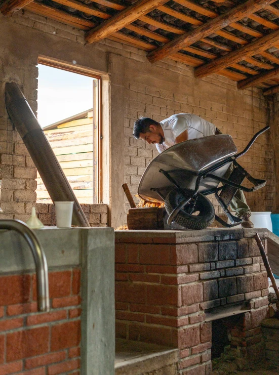 a woman is working with a wheel barrow on top of a block