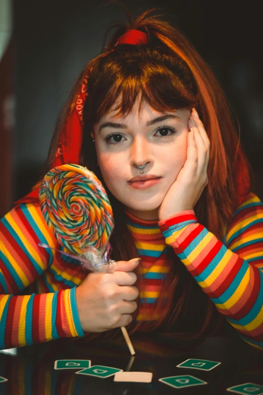 a woman leaning her head on top of a lollipop