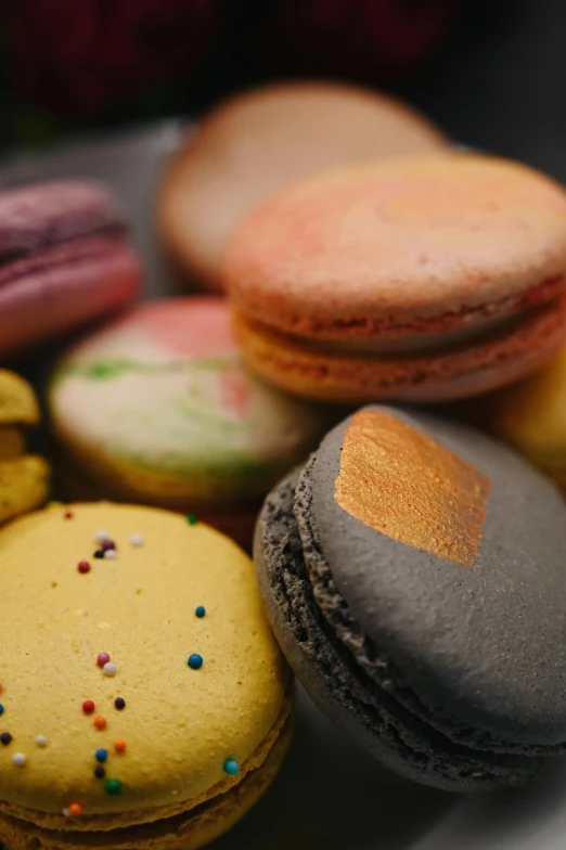 a plate with macaroons, cupcakes and cookies