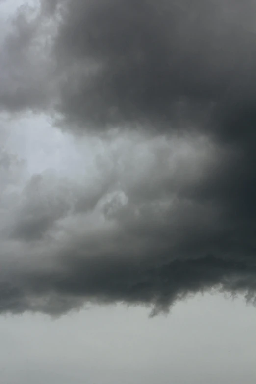 a lone airplane is seen in a black and white sky