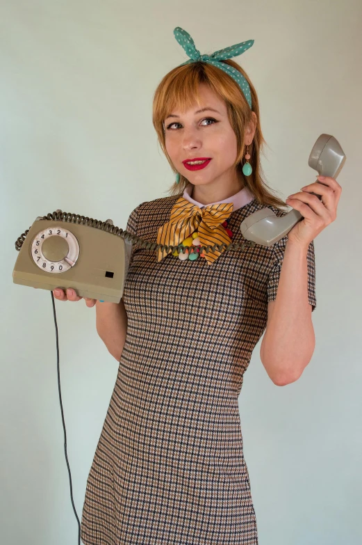 the woman in this dress is holding a hair dryer and a radio