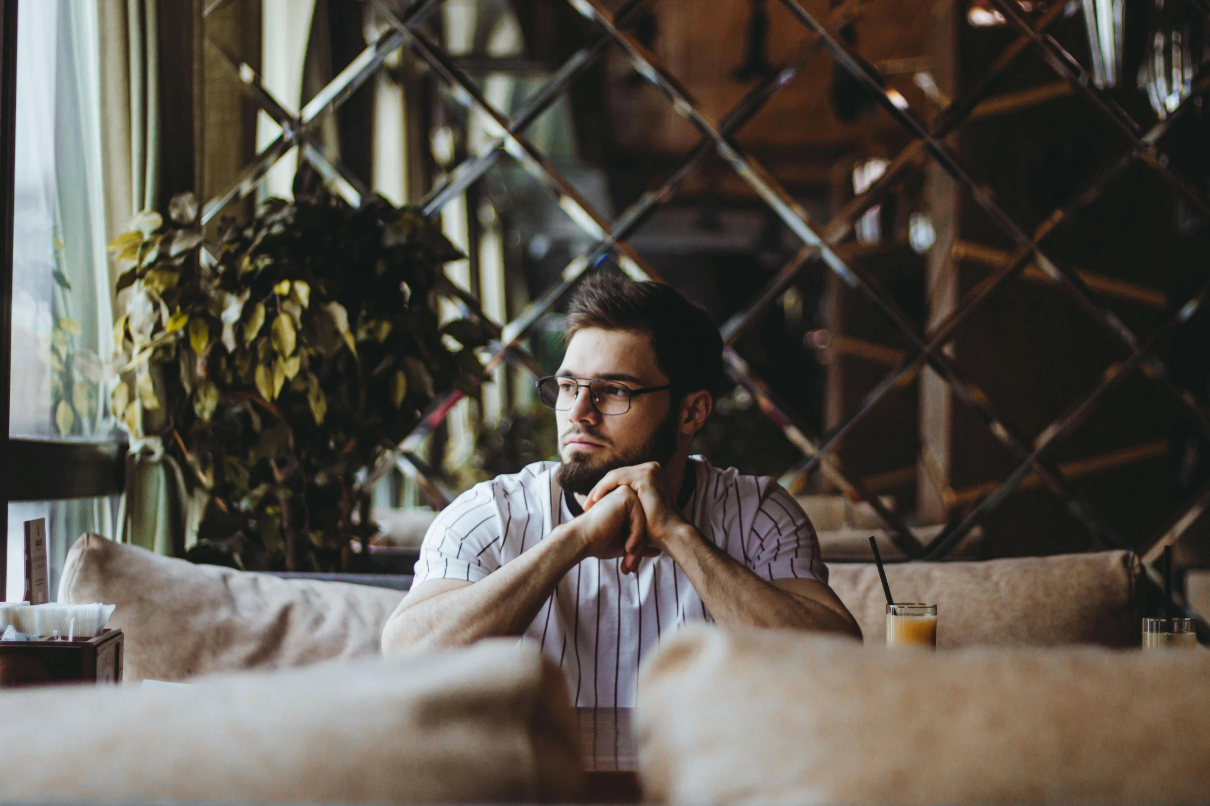 a man sitting on a couch looking at the camera