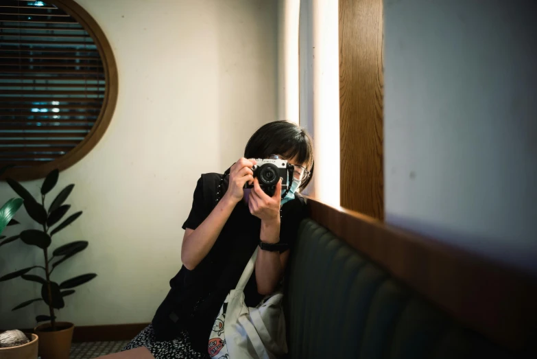 a woman takes a po while sitting in a chair