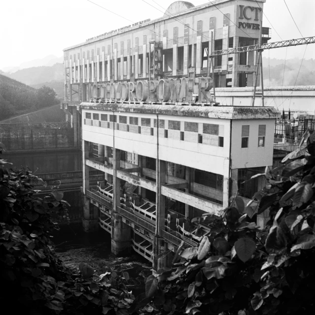 a building with lots of windows and stairs near water