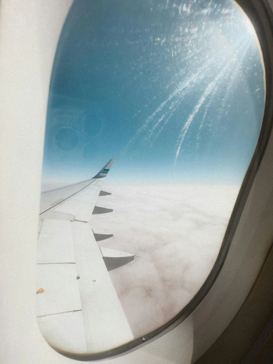 view out the window of an airplane showing the wing