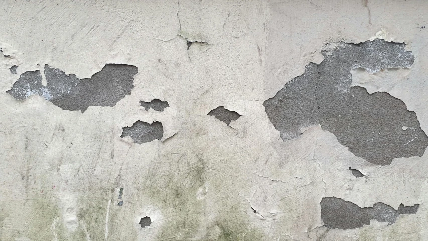 the paint peeling off of this concrete wall