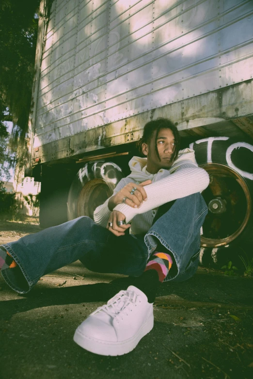 man sitting on a wooden bench and posing for the camera