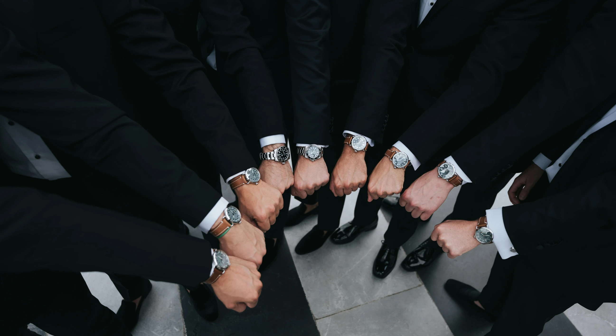 many men wearing white wristlets and ties in formation