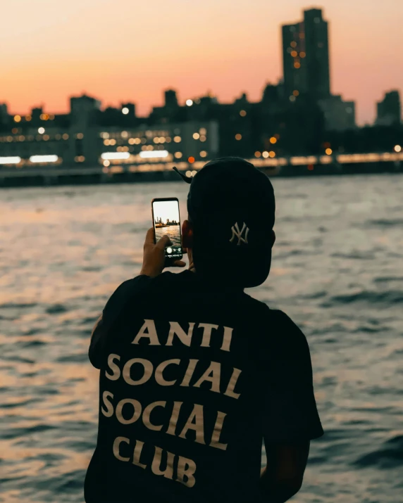 a person wearing a t - shirt that reads anti social social club