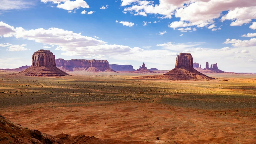 a scenic scene showing a few rock formations in the distance