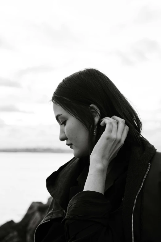 a woman in black coat talking on cell phone