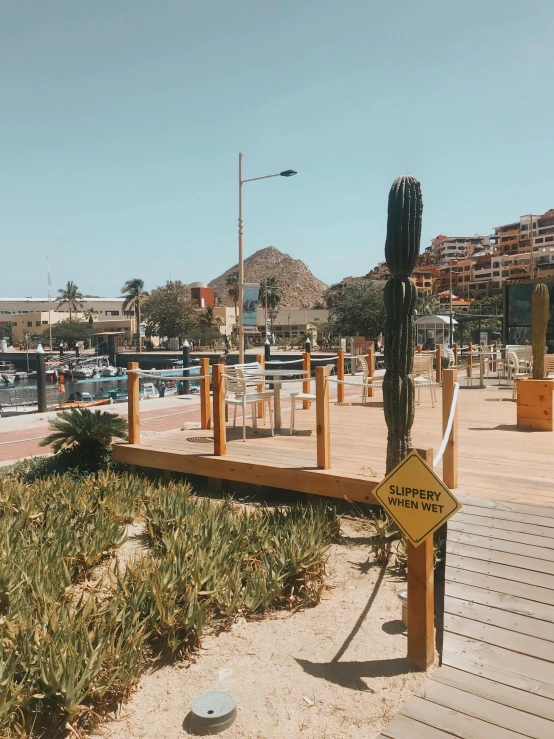 an arid beach is fenced off with wooden posts