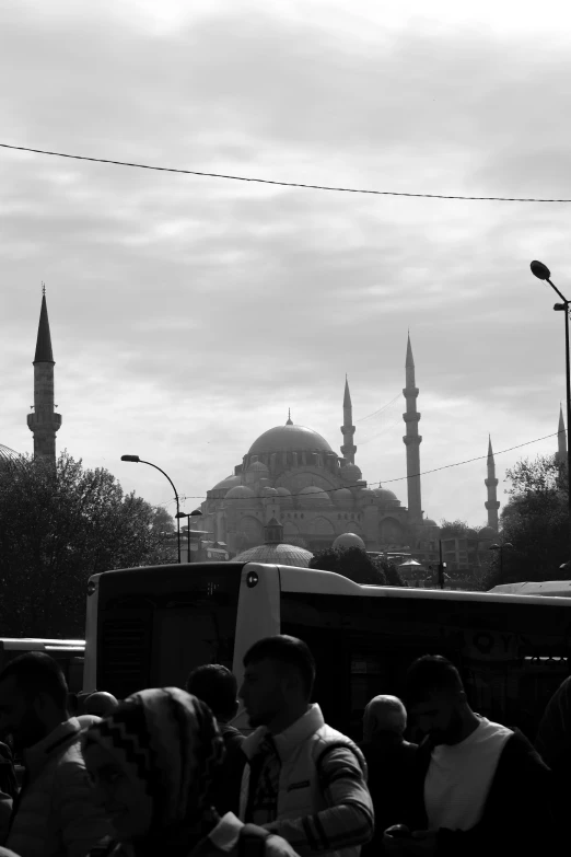 people are waiting for a bus on a crowded street