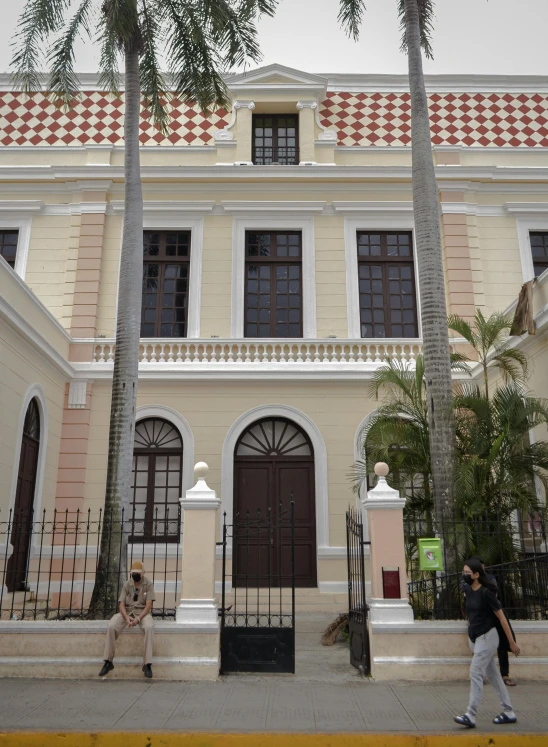 two people walking in front of a building