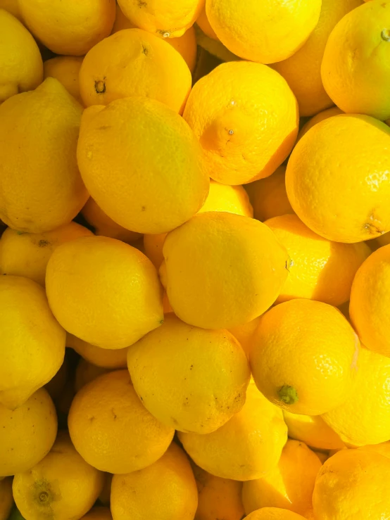 several lemons are piled together on display