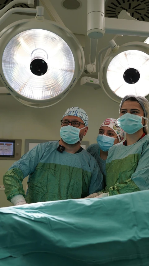 two surgeons in surgical suits wearing face masks