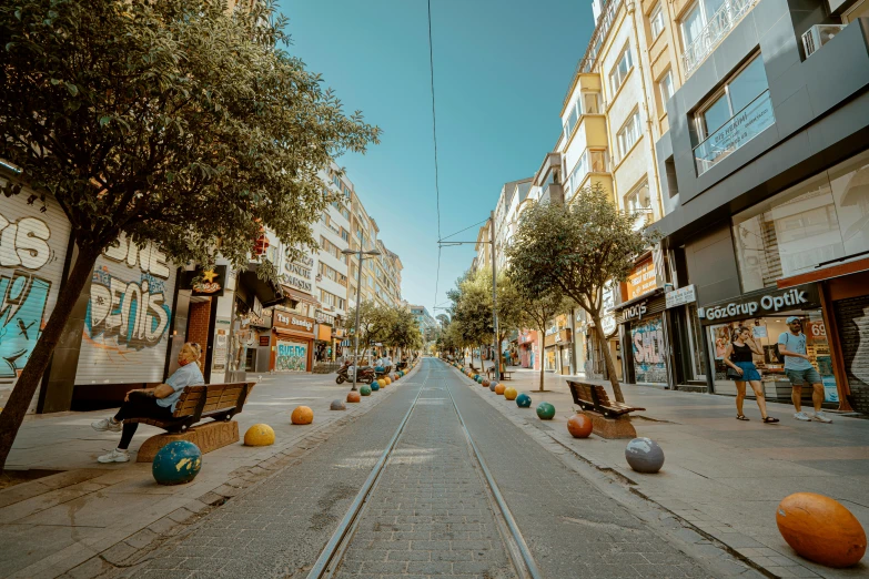 street view with orange and blue balls sitting in front of people