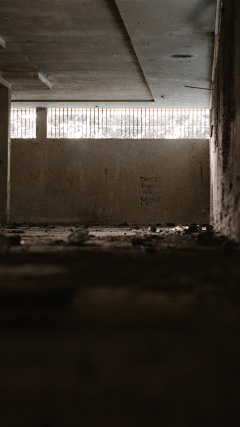 a vacant empty building with no windows and bars behind them