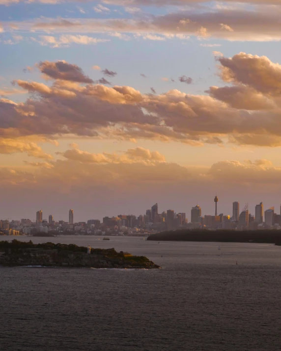 a large body of water with a city in the distance