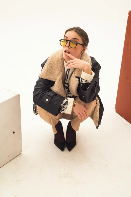 a woman in glasses has a handbag