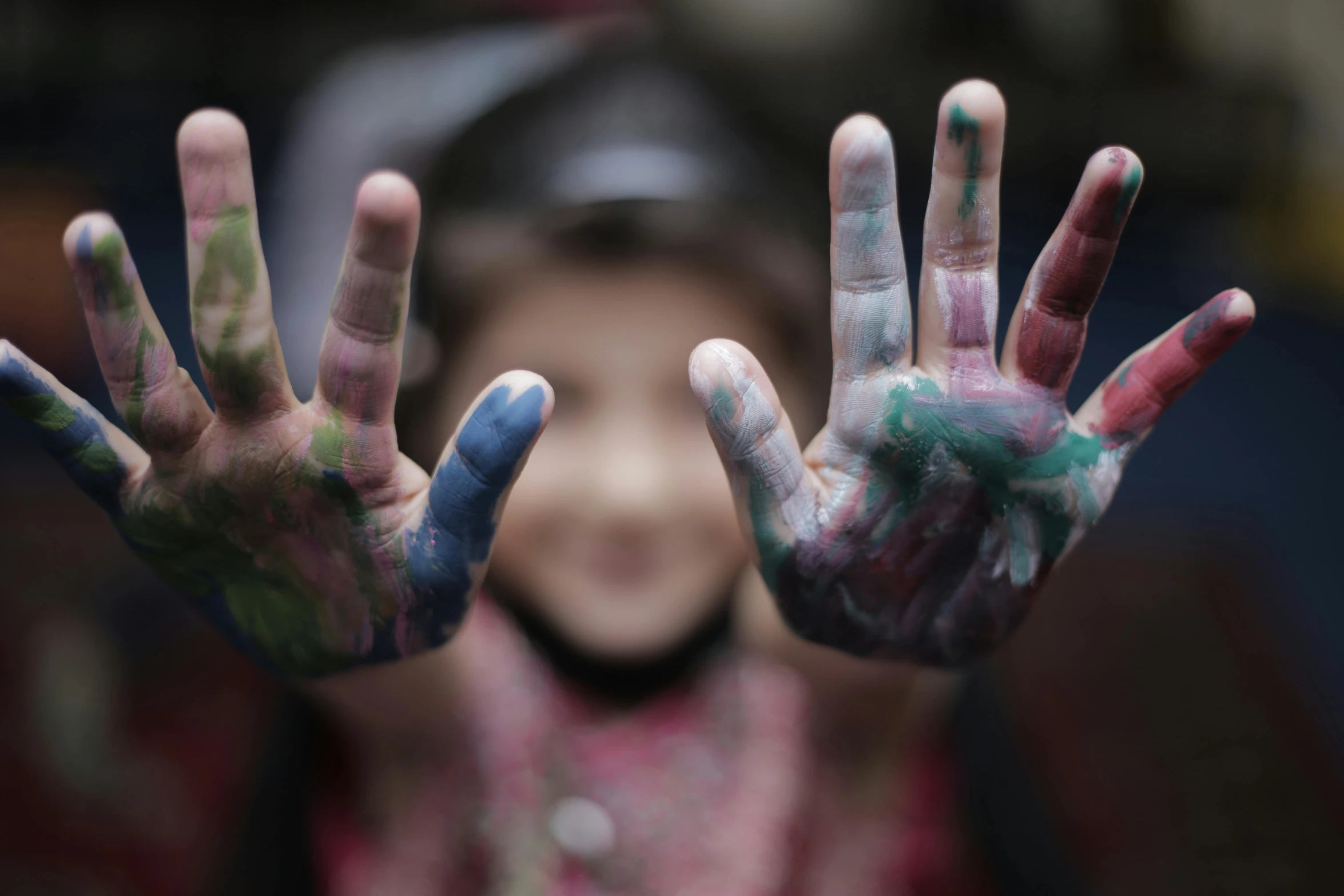 a woman is covered in paint covering her hands