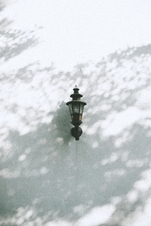 a street lamp in the midst of white clouds