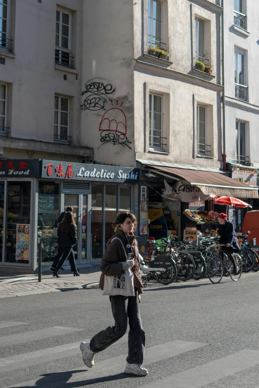 the woman is walking on the city street