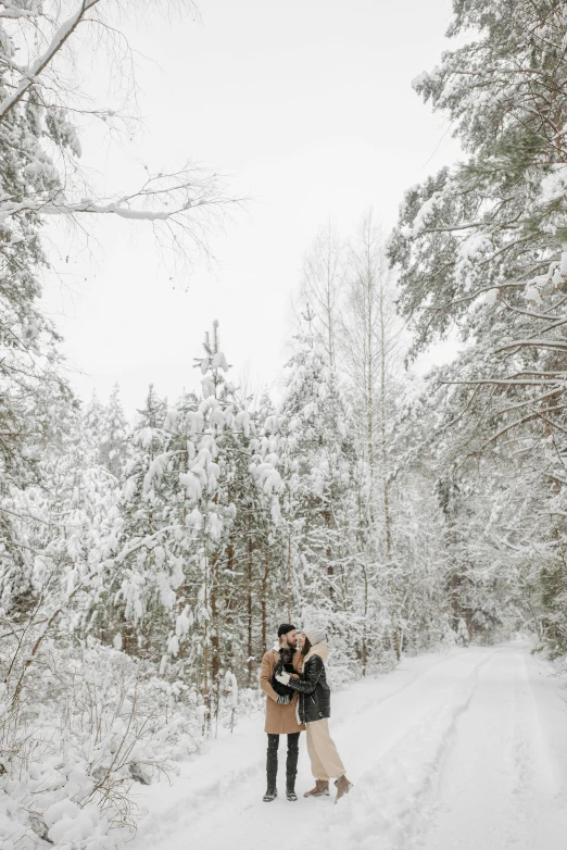 the couple is sharing a kiss in the middle of the snow