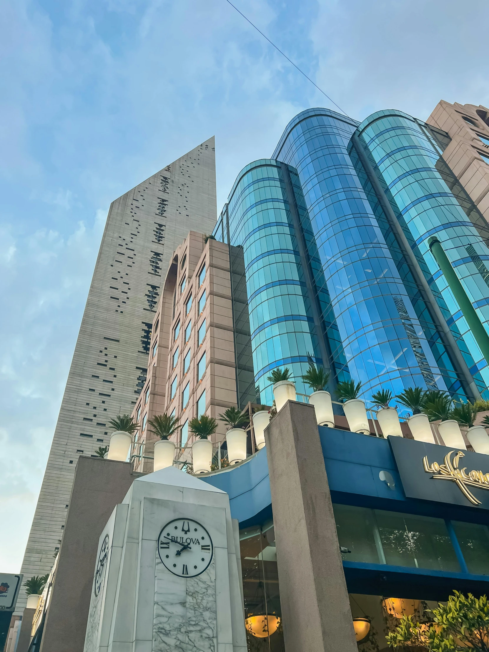 a very tall building in the city with clock on it