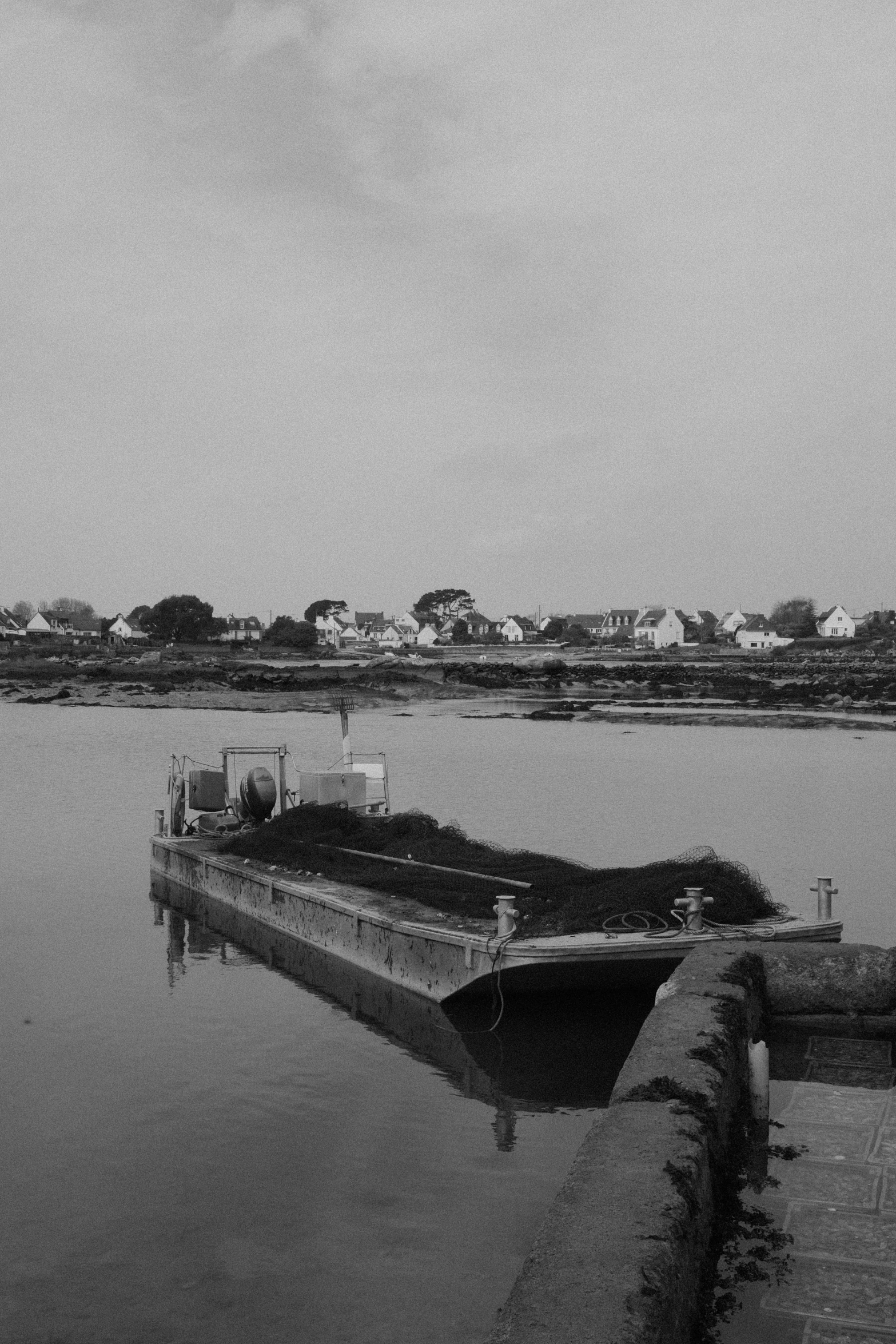 an old wooden boat is docked in the water