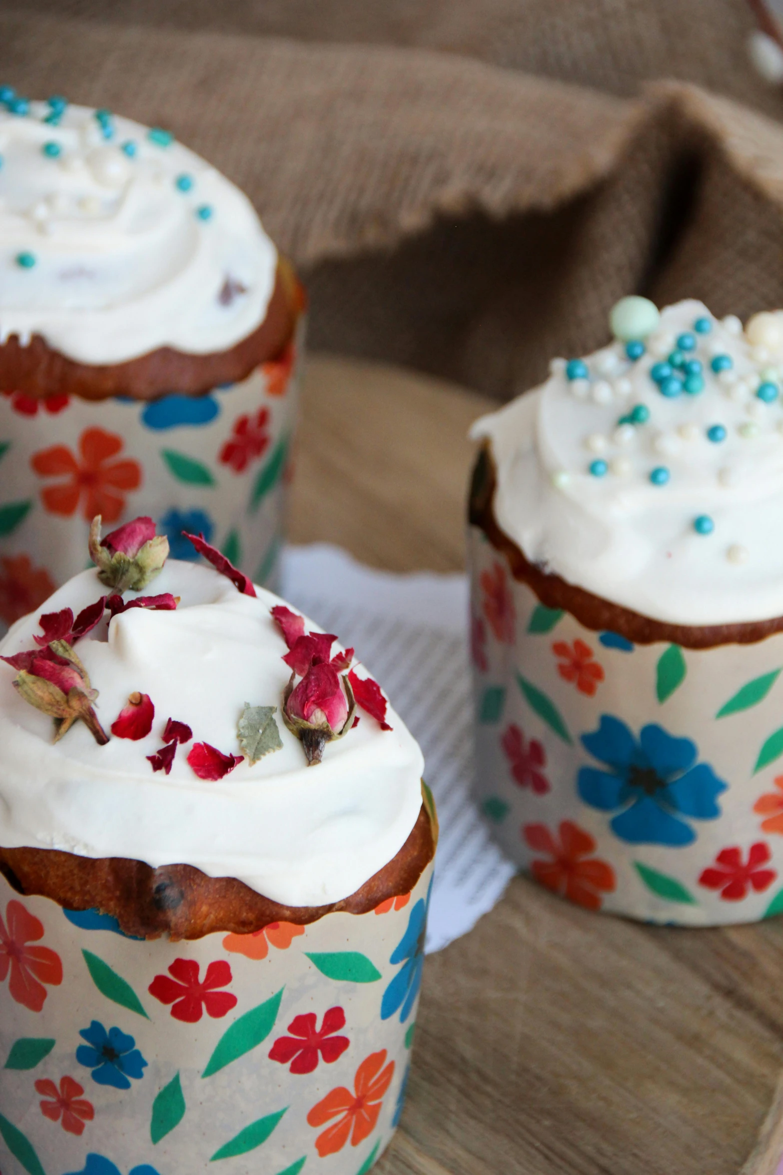 a close up of three cupcakes with frosting on them