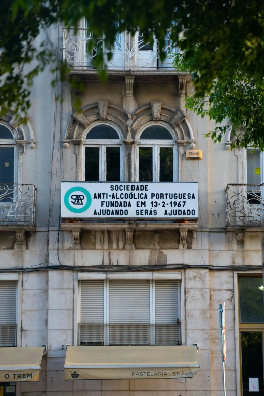 a large old building is showing a few signs